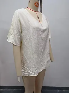 Detail view of a white V-neck crinkle texture loose blouse displayed on a mannequin
