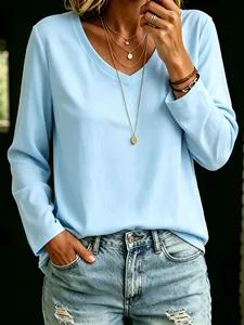 Close-up of a women's light blue V-neck long sleeve T-shirt styled with accessories