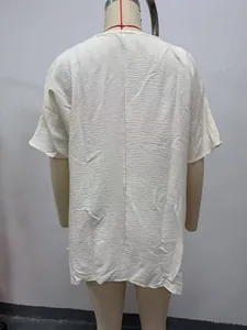 Detailed back view of a cream textured loose cover-up shirt featuring crinkled fabric