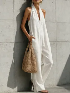 Close-up detail of an elegant white linen sleeveless jumpsuit for a chic summer look