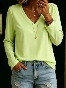 Detailed view of a vibrant lime green V-neck long-sleeve T-shirt showing fit and fabric