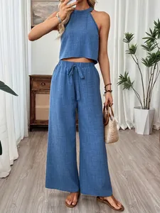 Two-piece summer set featuring a blue halter neck crop top and matching wide-leg trousers