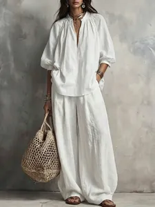 Λευκό boho σετ από βαμβάκι και λινό με πουκάμισο με φουσκωτά μανίκια και φαρδύ παντελόνι.