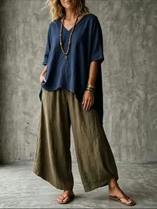 Bohemian style navy V-neck loose tunic paired with olive green linen wide-leg pants