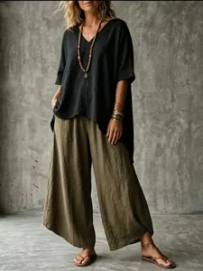 Boho style women's outfit featuring a black V-neck loose blouse and olive wide-leg pants