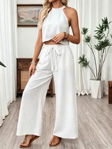 Full body detail of women's white linen halter crop top and wide-leg pants set