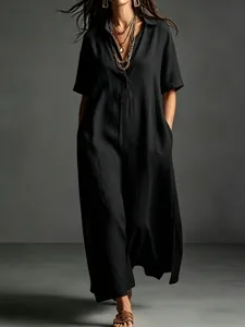 Detail view of an elegant black cotton linen short sleeve maxi dress with lapel.