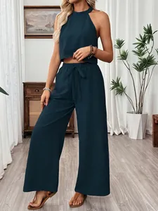 Detailed view of the dark teal halter crop top and matching wide-leg trousers set