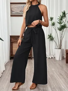 Detailed view of women's black halter neck top and wide-leg trousers casual set