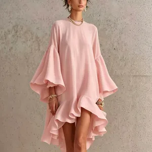Detailed view of an elegant pink dress with dramatic bell sleeves and ruffled asymmetric hem