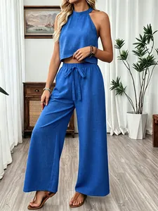 Cobalt blue two-piece set with a halter sleeveless crop top and wide-leg trousers.