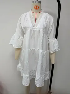 Detailed front view of a white V-neck lace mini dress displayed on a studio mannequin