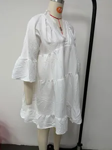 Side view of a white V-neck lace mini dress with bell sleeves on a professional mannequin