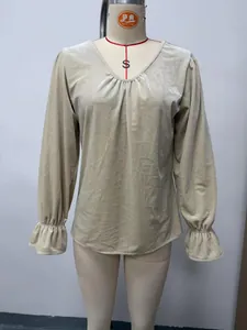 Detailed front view of beige V-neck velvet blouse with pleated neckline and ruffled cuffs