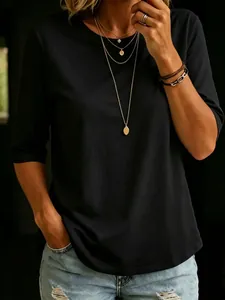 Close-up of a stylish black crew neck half-sleeve T-shirt paired with denim shorts.