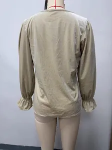 Back view detail of an elegant beige velvet long sleeve blouse with ruffled elastic cuffs