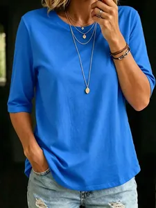 Detail showing the royal blue fabric texture and fit of the crew neck top on a model