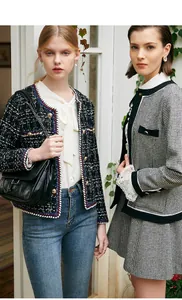 Classic houndstooth and navy tweed jackets shown on models in a bright outdoor setting.