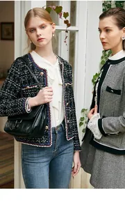 Detailed view of elegant black and white tweed jackets featuring vintage gold buttons