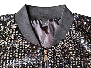 Close-up detail of a sparkly black sequin baseball jacket featuring the neck label