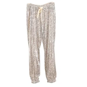 Detail shot of shimmering silver sequin joggers with elastic waist and drawstring.