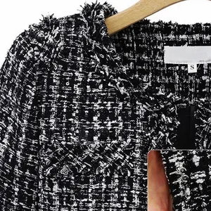 Classic black and white checkered tweed jacket with hook-and-eye closure detail
