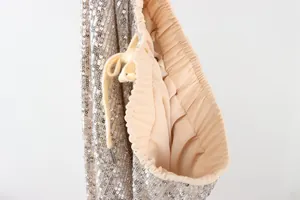 Close-up of elastic waistband on champagne sequin pants with soft lining