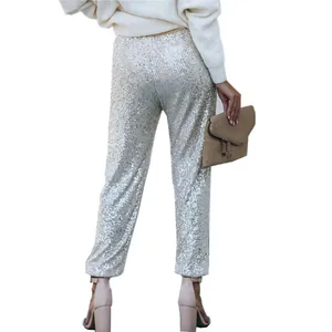 Detailed view of shimmering silver sequins on fashionable women's party pants