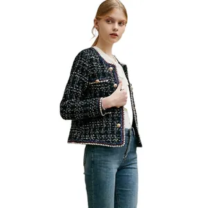 Elegant black and white plaid double-breasted tweed jacket with decorative gold buttons