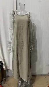Full length view of a khaki linen cotton blend slip dress with side slits on a mannequin