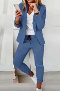 Detail view of a woman wearing a stylish blue casual two-piece blazer and trousers set.