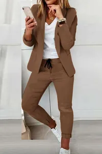 Detailed view of women's casual brown two-piece suit with blazer and trousers