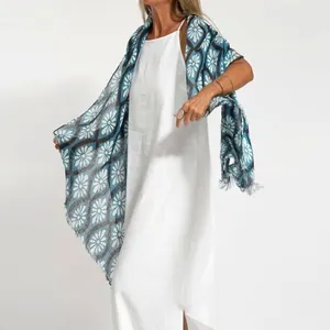 Close-up detail of a white cotton linen sleeveless midi dress styled with a blue floral scarf