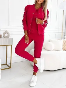 Close-up of a magenta three-piece tracksuit with stylish side stripe details.