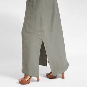 Detailed view of an olive green cotton linen maxi dress featuring a side slit.