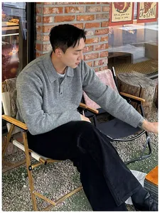 Casual men's grey polo neck knit sweater shown in an outdoor cafe lifestyle setting