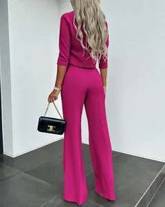 Elegante vista trasera de un traje fucsia de dos piezas con pantalón ancho y blazer