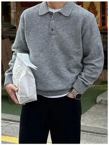 Close-up of a stylish grey men's polo collar knit sweater with soft and cozy texture