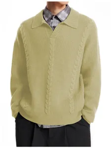 Close-up of men's beige cable knit polo sweater with retro collar detail