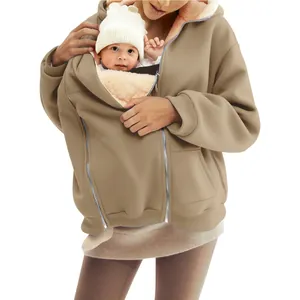 Detail of women's winter fleece hoodie featuring a functional baby carrier pocket.