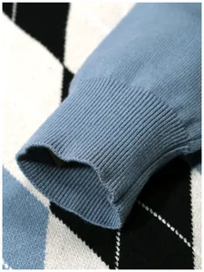 Detailed close-up of light blue ribbed cuff on a classic argyle jacquard knit sweater
