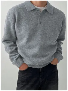 Close-up view of a men's grey knit polo sweater showing the collar and button details