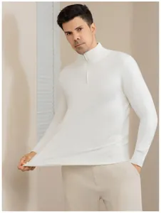 Detail of white half-zip mock neck sweater showing flexible knitted fabric texture
