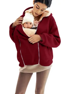 Oversized burgundy fleece hoodie for women featuring a kangaroo baby carrier pocket