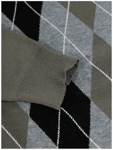Close-up of the ribbed cuff on a men's argyle pattern jacquard knitted sweater.