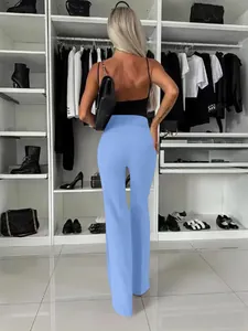 Detail achteraanzicht van een elegante lichtblauwe broek met wijde pijpen in een inloopkast