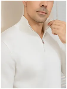 Close-up of white men's half-zip polo knit sweater collar and zipper detail