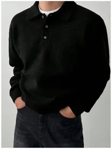 Detailed macro view of men's black knit polo sweater with button placket and soft texture