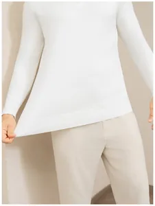 Close-up detail of white knitted men's long-sleeve polo sweater with elastic hem