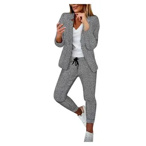 Detail of women's grey herringbone 2-piece casual blazer and trousers suit set.